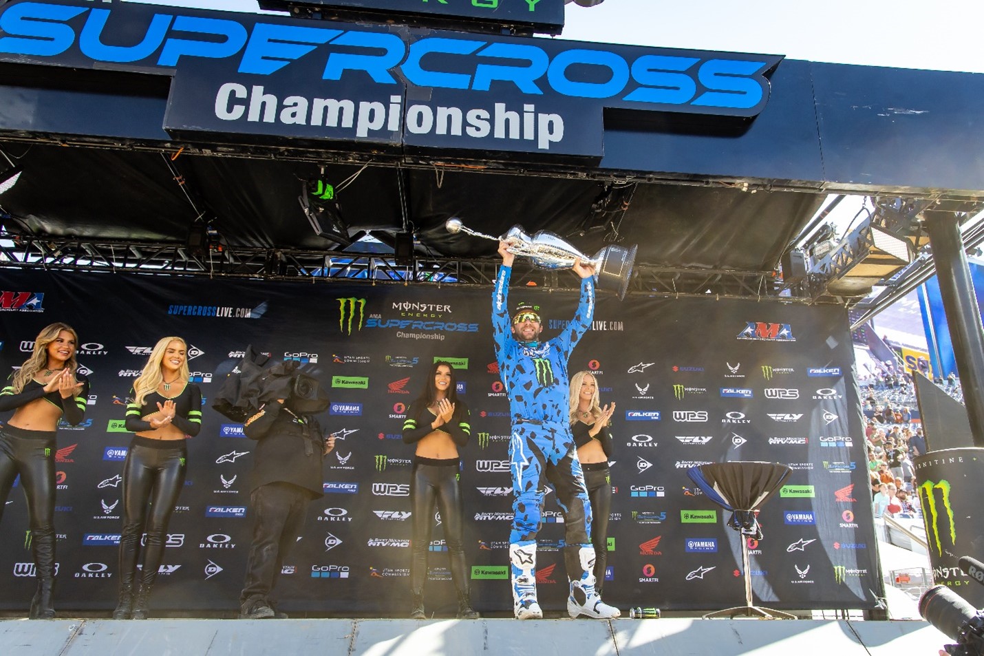 Eli Tomac hoisting the Monster Energy AMA Supercross Championship trophy after clinching his second world championship in Denver at Empower Field at Mile High Stadium. Photo Credit: Feld Motor Sports