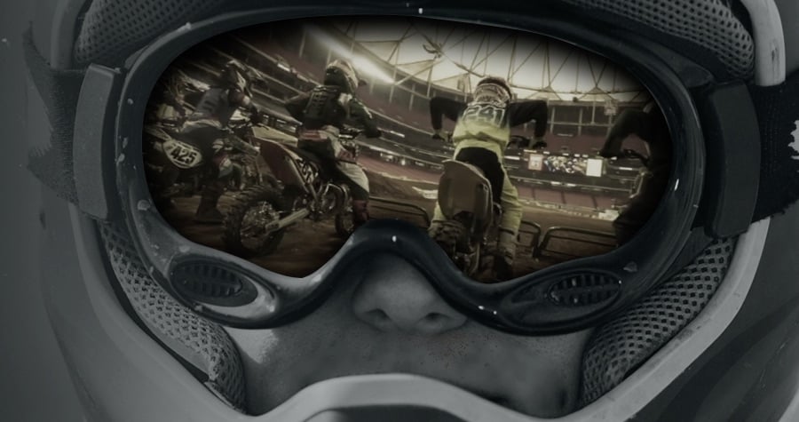 Motocross goggles with reflection at racetrack