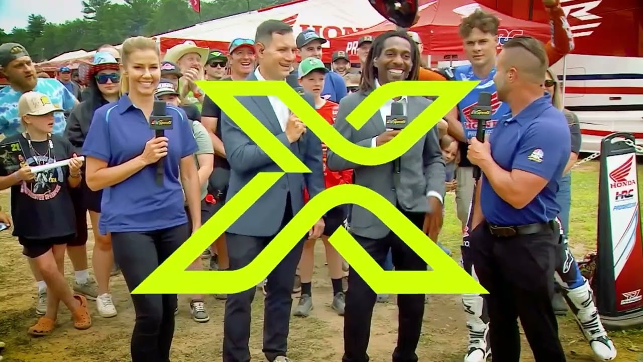 Screengrab of SMX broadcast presenters talking in front of a crowd with part of the SMX logo