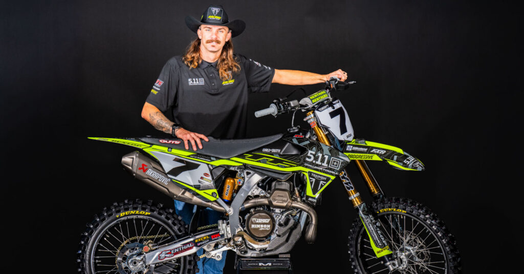 Aaron Plessinger standing next to a Triumph SMX motorcycle