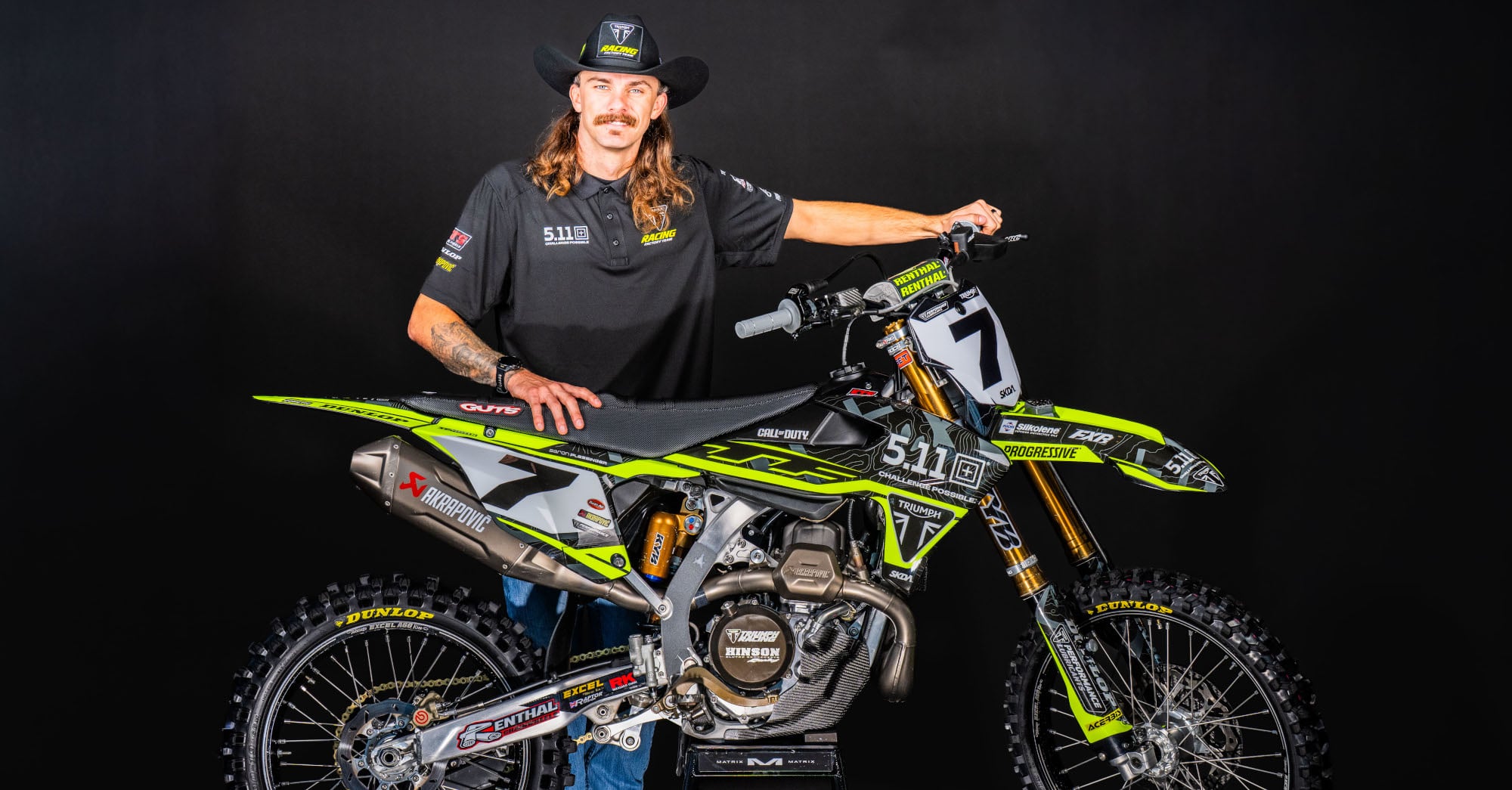 Aaron Plessinger standing next to a Triumph SMX motorcycle