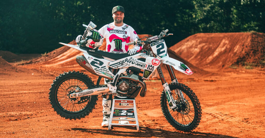 Cooper Webb standing with a Husqvarna motorcycle