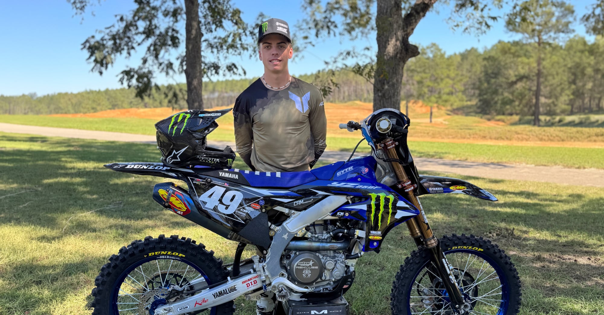 Casey Cochran standing next to a Yamaha motorcycle